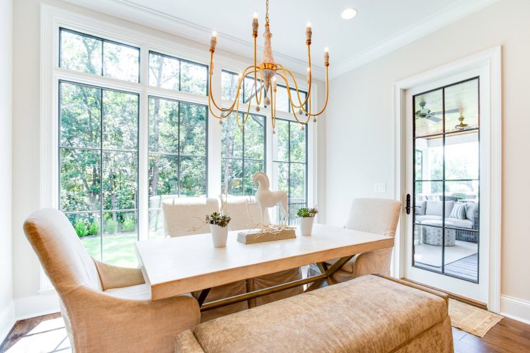 Kitchen Table Surrounded by Large Windows